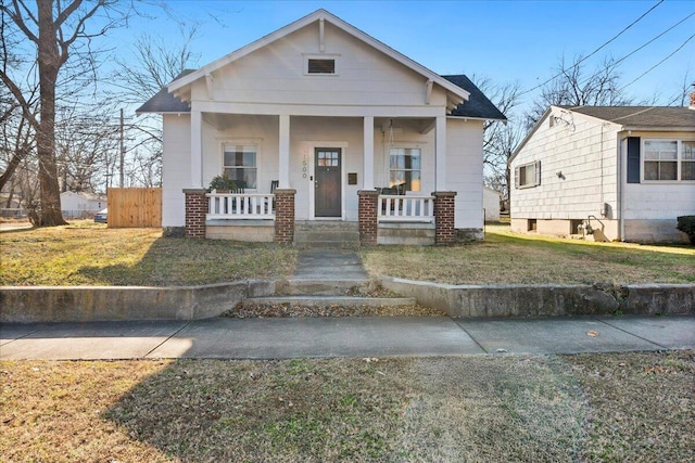 bungalow-style home featuring a porch and a front lawn