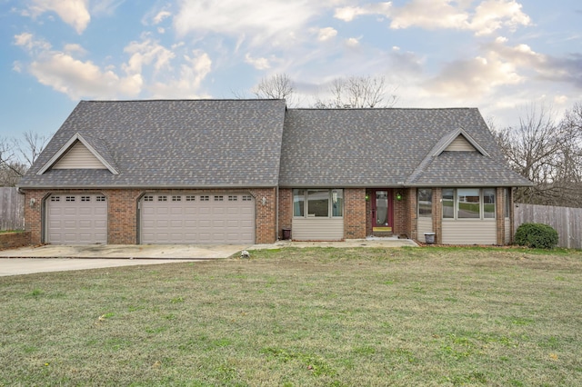 ranch-style house featuring a garage and a front yard