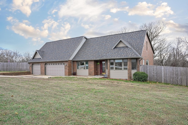 view of front of home with a garage and a front lawn