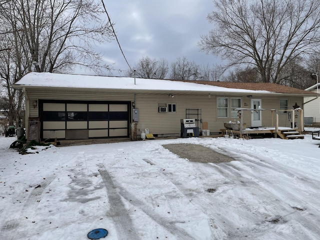 snow covered property featuring a garage