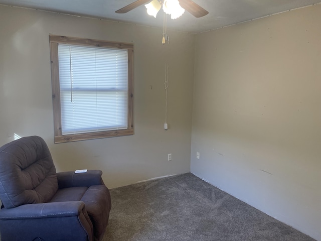 living area with ceiling fan and carpet flooring