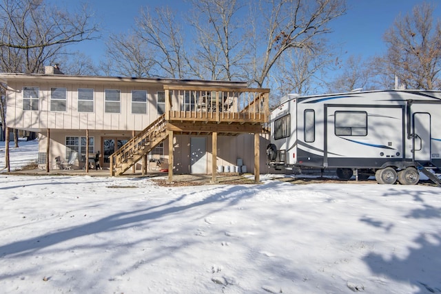 snow covered property featuring a deck