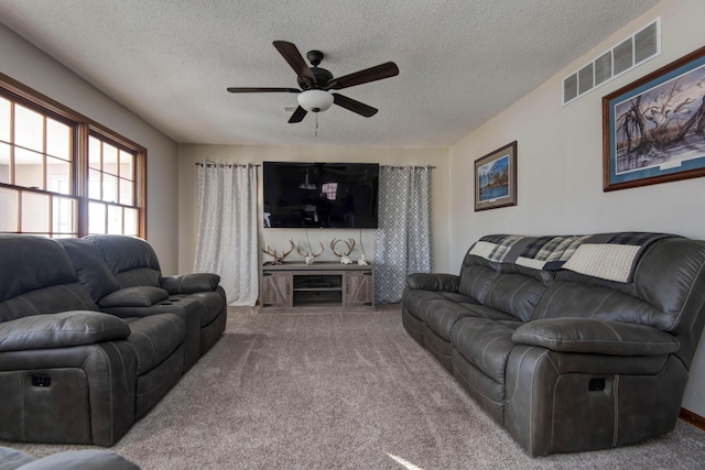 living room featuring carpet, a textured ceiling, and ceiling fan