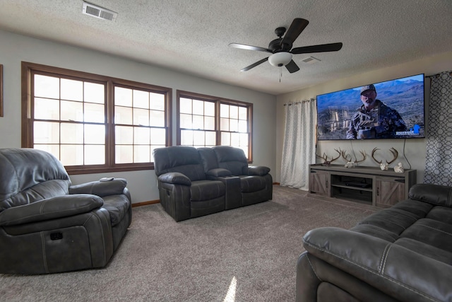 living room with carpet flooring, ceiling fan, a healthy amount of sunlight, and a textured ceiling