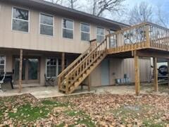 back of house featuring a patio and a wooden deck