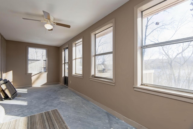 interior space with ceiling fan