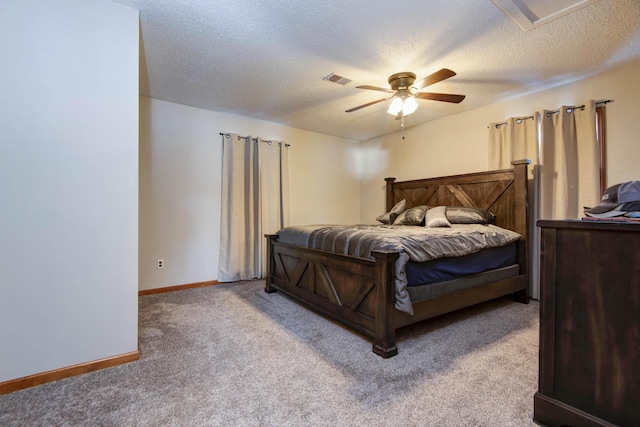 bedroom featuring a textured ceiling, ceiling fan, and light carpet