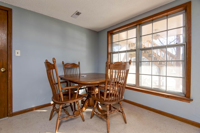 dining area with a textured ceiling