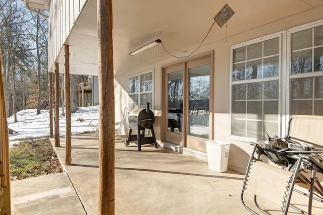 snow covered patio featuring grilling area