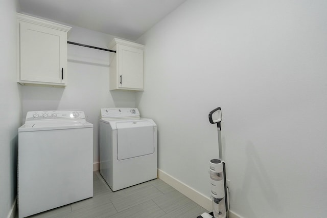 clothes washing area featuring cabinets, independent washer and dryer, and light tile patterned flooring