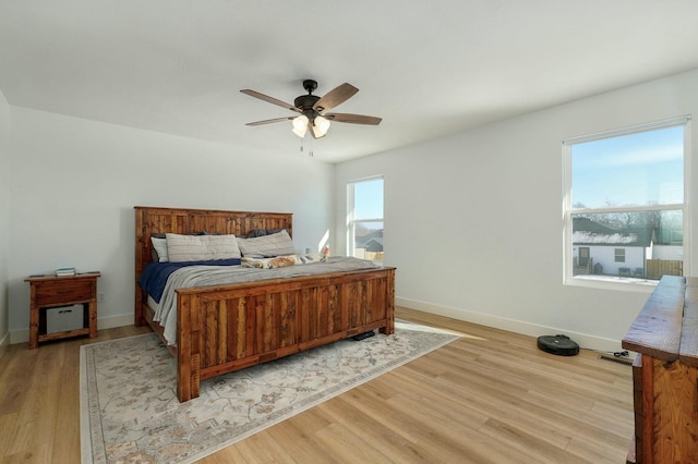 bedroom with ceiling fan and light hardwood / wood-style flooring