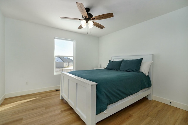 bedroom with ceiling fan and light wood-type flooring