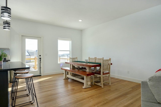 dining space with light hardwood / wood-style flooring