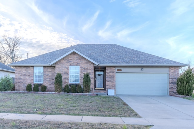 single story home with a front yard and a garage