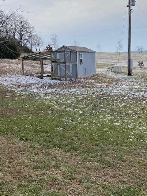 view of outdoor structure with a rural view and central AC