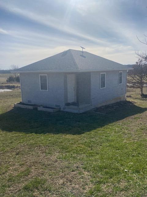 rear view of house with a yard