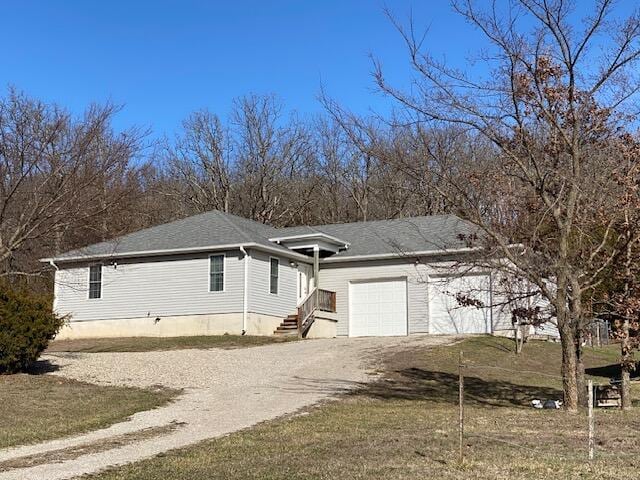 view of front of home featuring driveway and a garage