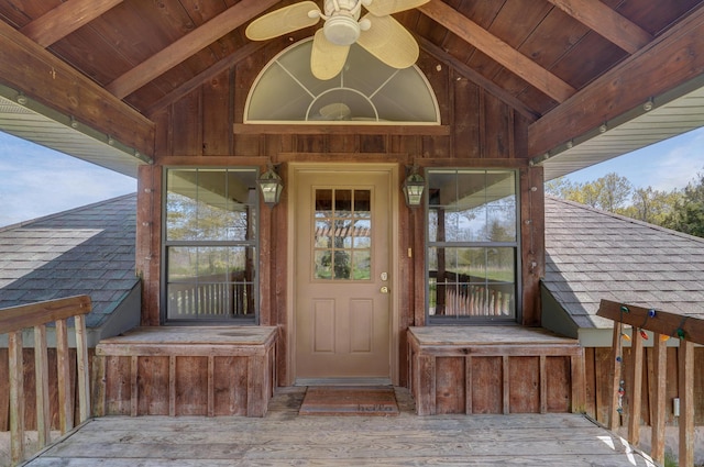 doorway to property with ceiling fan and a wooden deck