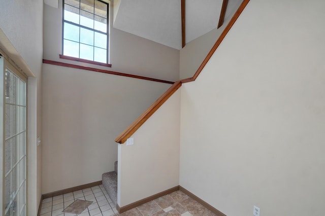 staircase with a towering ceiling