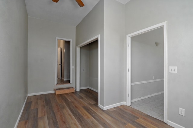 unfurnished bedroom featuring dark hardwood / wood-style flooring, a closet, and ceiling fan