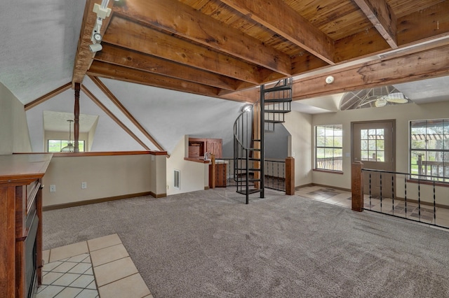 unfurnished living room featuring beam ceiling, light colored carpet, and wood ceiling