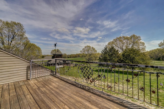 wooden deck featuring a yard