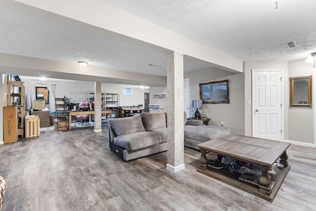 living room with hardwood / wood-style flooring and a textured ceiling