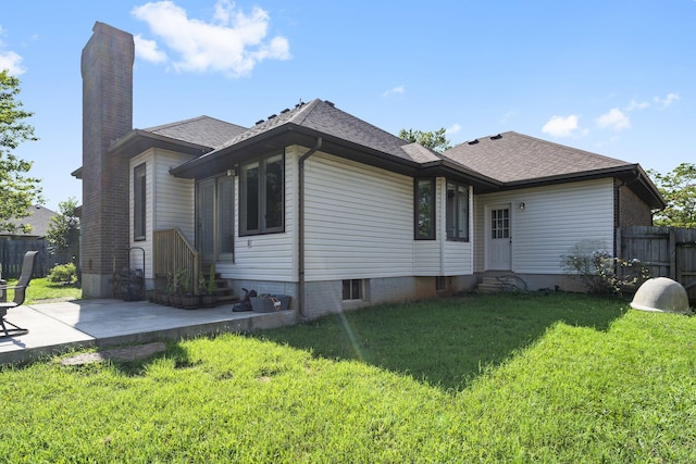 rear view of property featuring a patio area and a lawn