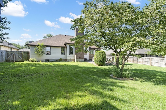 rear view of house with a lawn