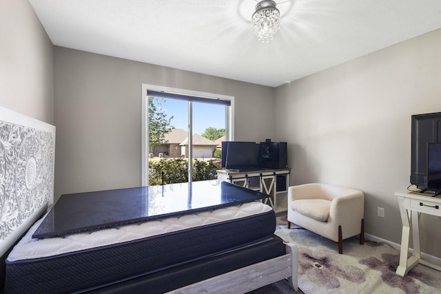 carpeted bedroom with access to exterior and a notable chandelier