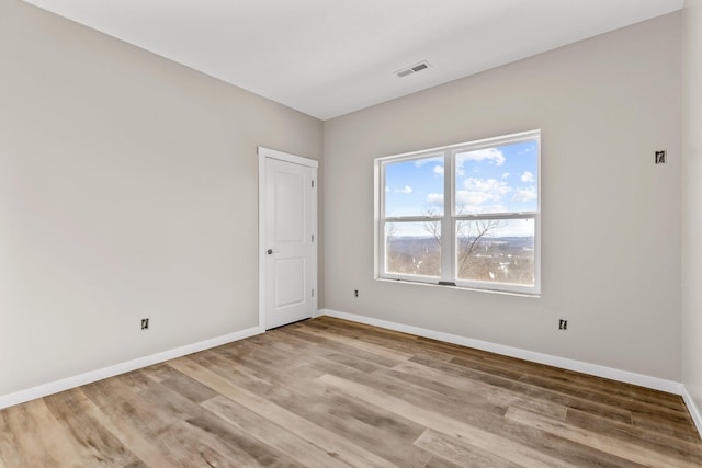 spare room with light wood-type flooring