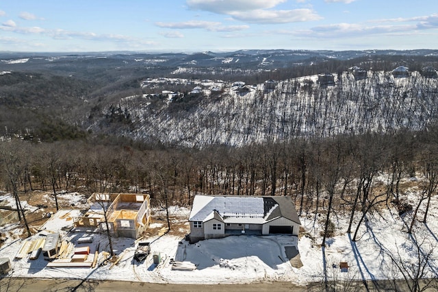 snowy aerial view with a view of trees