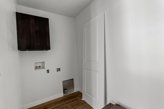 clothes washing area with dark wood-type flooring and washer hookup