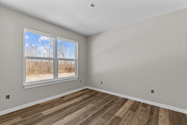 unfurnished room with wood-type flooring