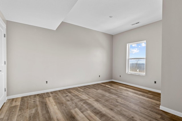 spare room featuring hardwood / wood-style flooring