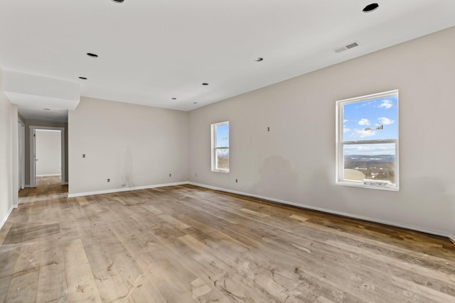 empty room featuring light hardwood / wood-style flooring and a healthy amount of sunlight