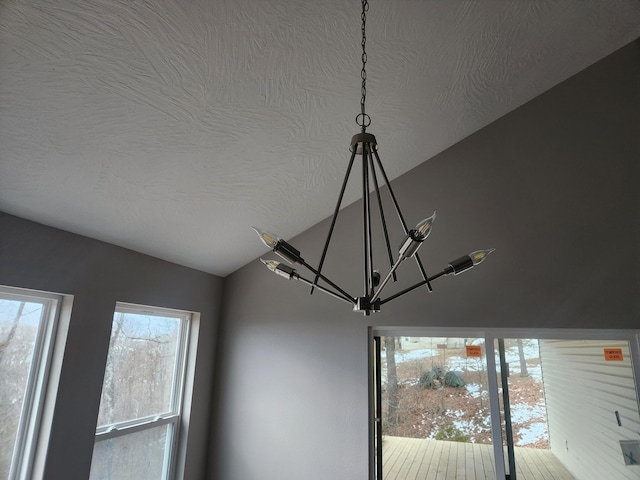 details featuring a textured ceiling and a notable chandelier