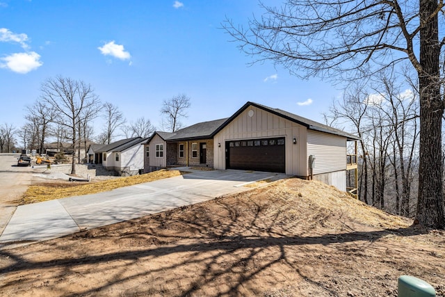 view of front of property with board and batten siding, concrete driveway, and an attached garage