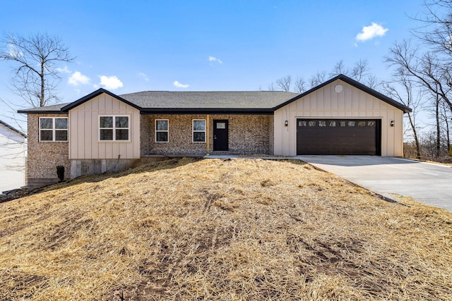 view of front of property with a garage, roof with shingles, board and batten siding, and concrete driveway