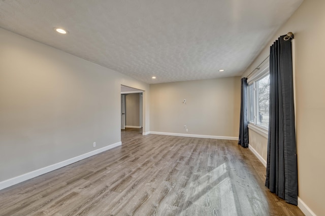 empty room with light hardwood / wood-style flooring