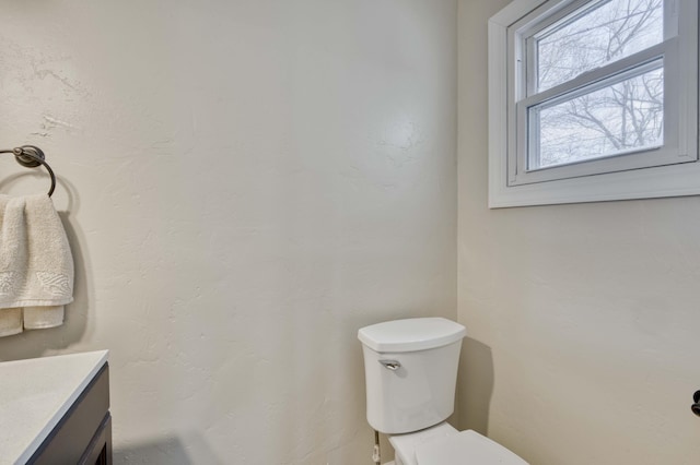 bathroom featuring toilet and vanity