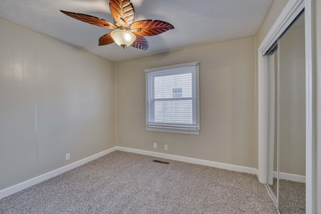 unfurnished bedroom with a closet, ceiling fan, and carpet floors