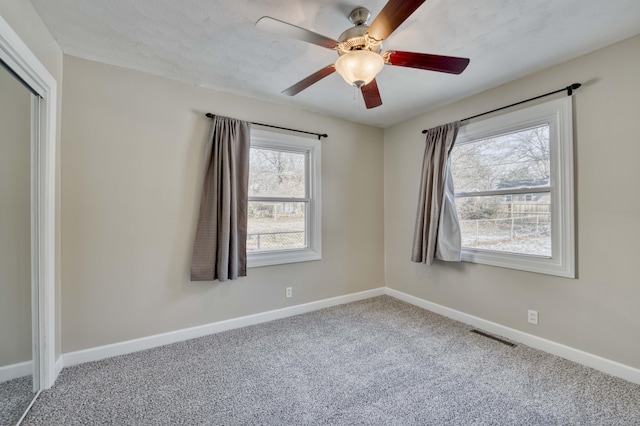 spare room featuring carpet floors and ceiling fan