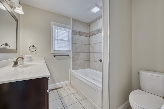 full bathroom with tile patterned flooring, tiled shower / bath combo, vanity, and toilet