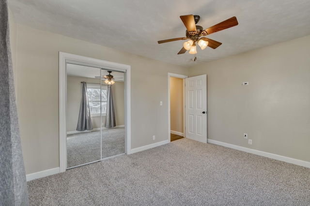 unfurnished bedroom featuring ceiling fan, a closet, and carpet