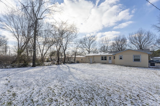 view of snow covered rear of property