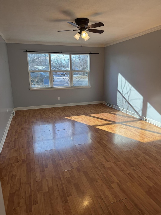 unfurnished room with ceiling fan, hardwood / wood-style floors, and crown molding