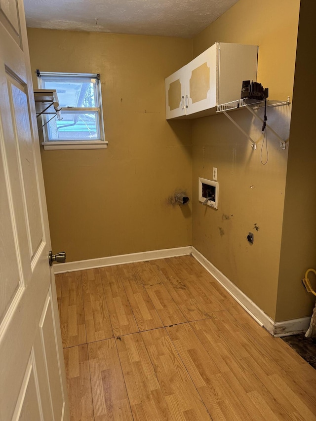 washroom featuring washer hookup, light wood-type flooring, a textured ceiling, and hookup for a gas dryer