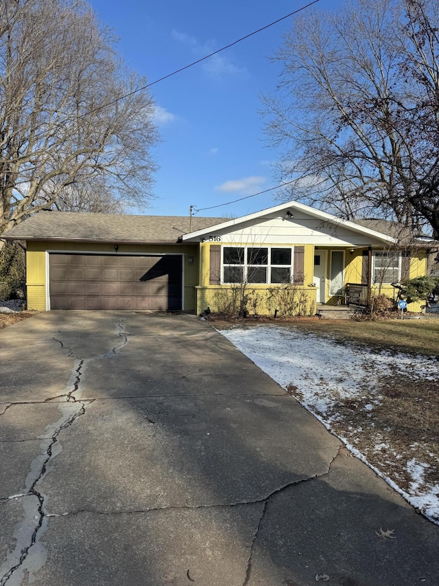 ranch-style house with a porch and a garage