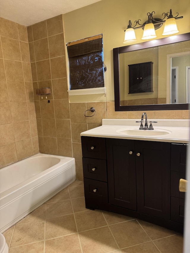 bathroom featuring tile patterned floors, vanity, tile walls, and shower / tub combination